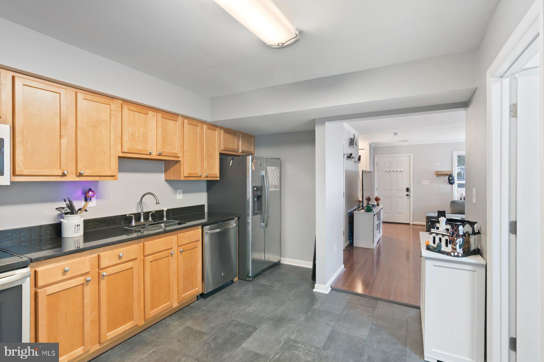584 Cotswold Court Frederick, MD 21703 - Photo 6 of 21 a kitchen with stainless steel appliances granite countertop a refrigerator and sink
