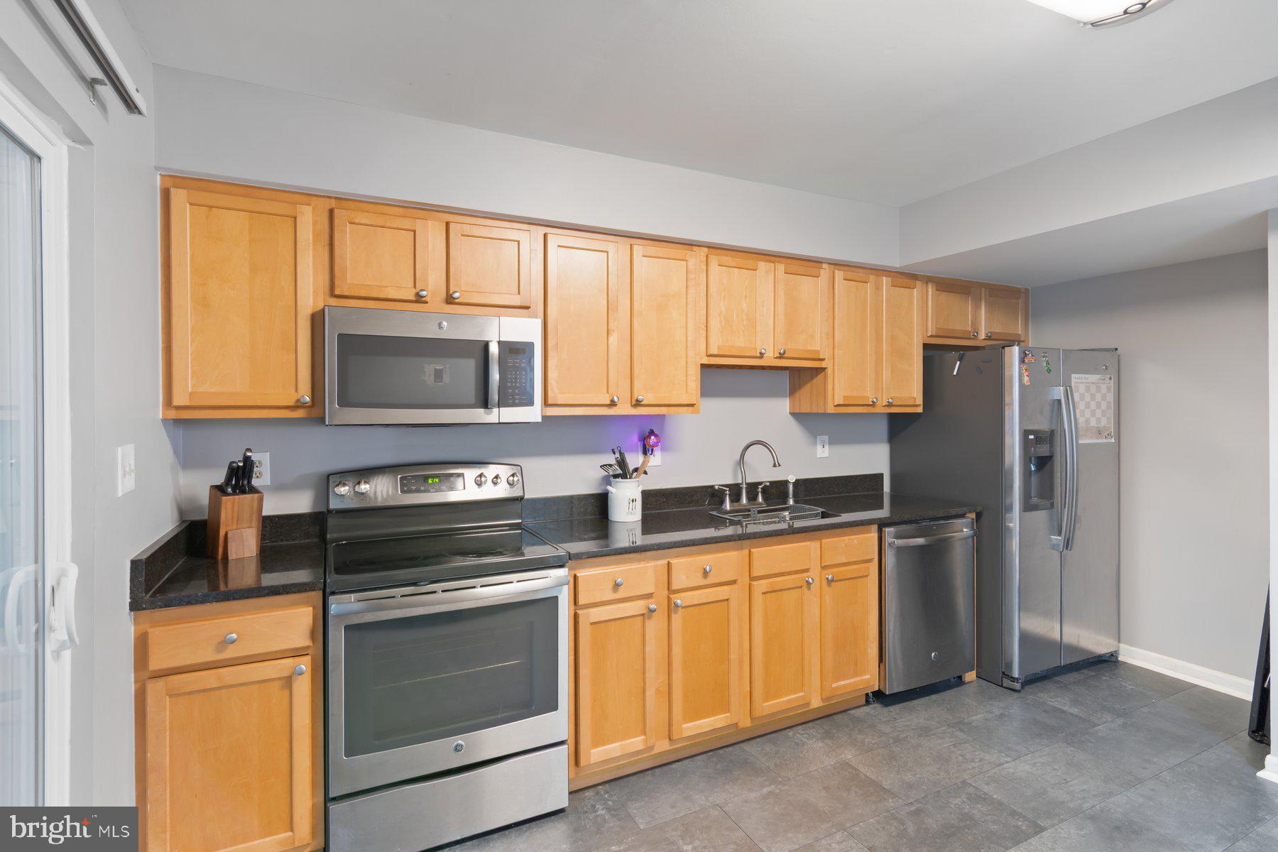584 Cotswold Court Frederick, MD 21703 - Photo 7 of 21 a kitchen with stainless steel appliances granite countertop a stove a sink a refrigerator and cabinets