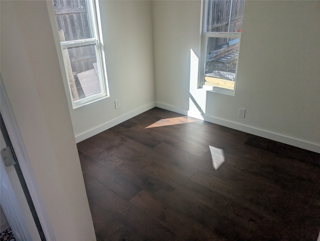 3019 East 12th Street Austin, TX 78702 - Photo 11 of 12 an empty room with wooden floor and windows