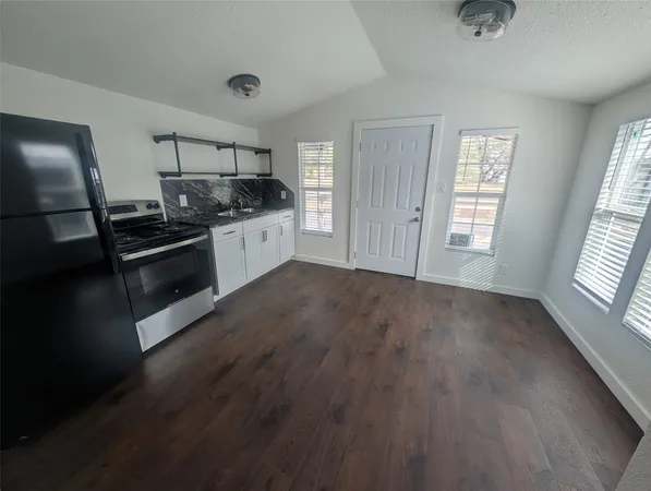 a kitchen with stainless steel appliances granite countertop a stove and a refrigerator