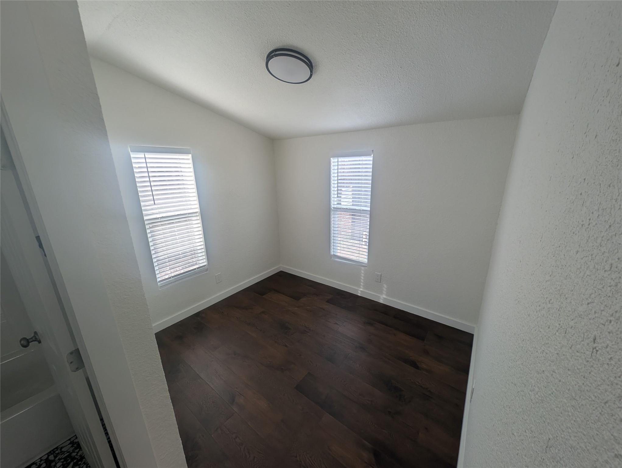 3019 East 12th Street Austin, TX 78702 - Photo 8 of 12 an empty room with wooden floor and windows