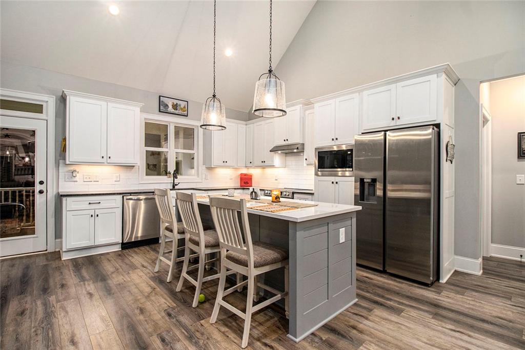 17 Wendover Drive Cartersville, GA 30120 - Photo 13 of 32 a kitchen with stainless steel appliances a table chairs refrigerator and cabinets
