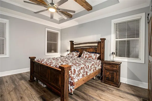 a bed sitting in a bedroom next to a window