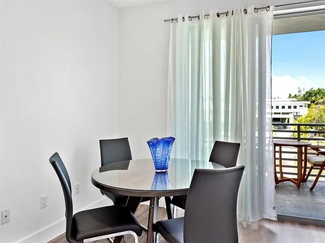 a view of a dining room with furniture and window