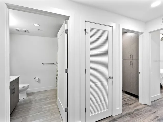 a bathroom with a sink toilet vanity and shower