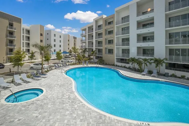 a view of a swimming pool with outdoor seating