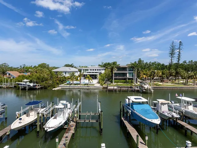 a view of a lake with boats and trees in the background