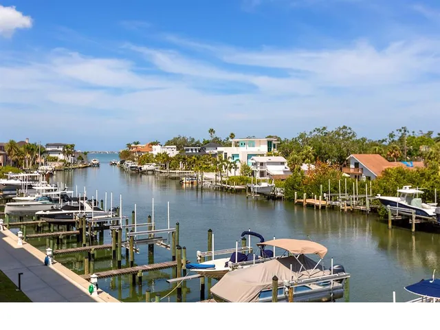 a view of a lake with boats and trees in the background