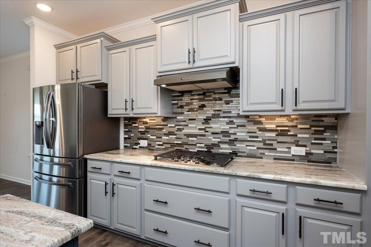 434 Streamliner Boulevard Clayton, NC 27520 - Photo 11 of 27 a kitchen with stainless steel appliances granite countertop a refrigerator sink and cabinets