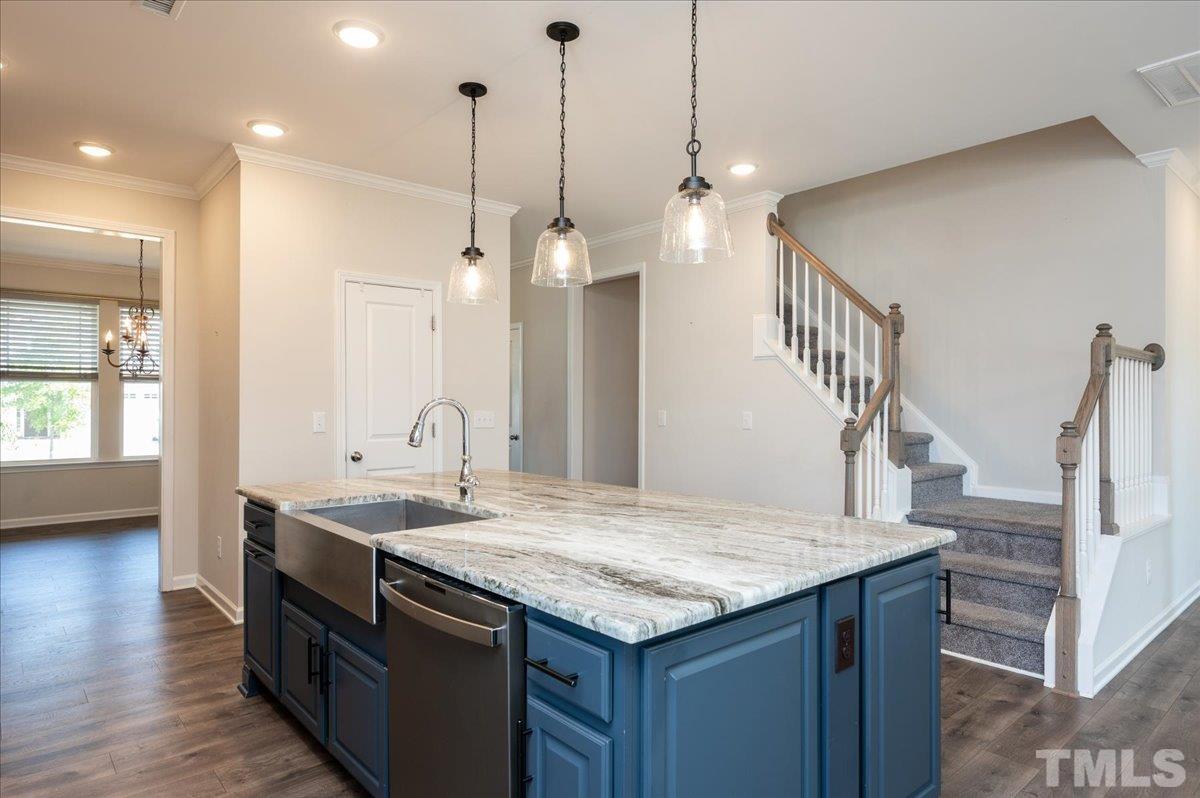 434 Streamliner Boulevard Clayton, NC 27520 - Photo 12 of 27 a kitchen with a sink a counter space and wooden floor
