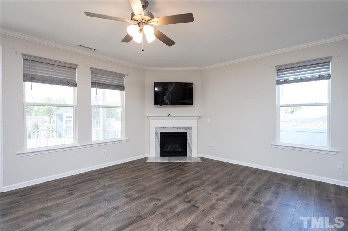 434 Streamliner Boulevard Clayton, NC 27520 - Photo 14 of 27 a living room with a fireplace and flat screen tv