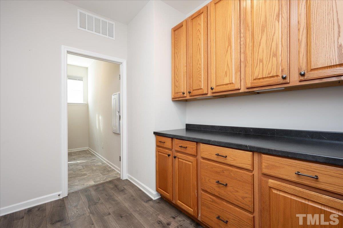 434 Streamliner Boulevard Clayton, NC 27520 - Photo 15 of 27 a view of cabinets with wooden floor