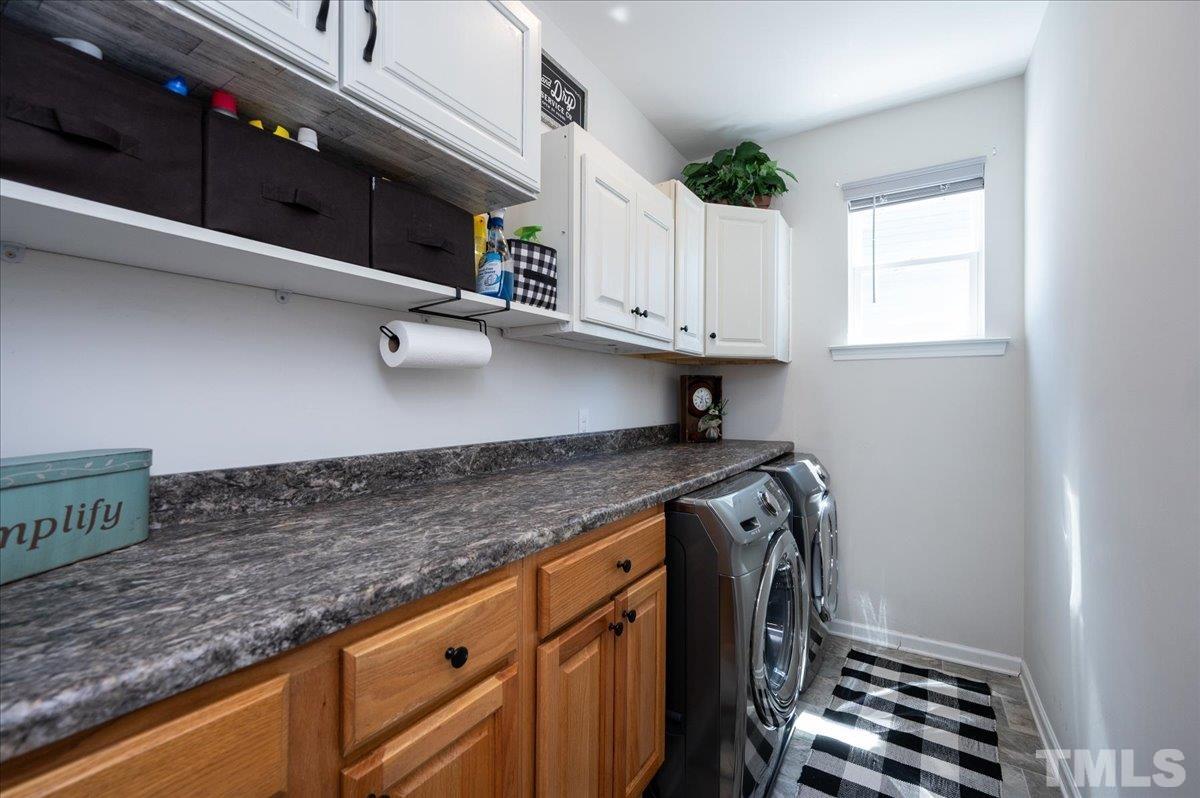 434 Streamliner Boulevard Clayton, NC 27520 - Photo 16 of 27 a kitchen with granite countertop a sink a stove and cabinets