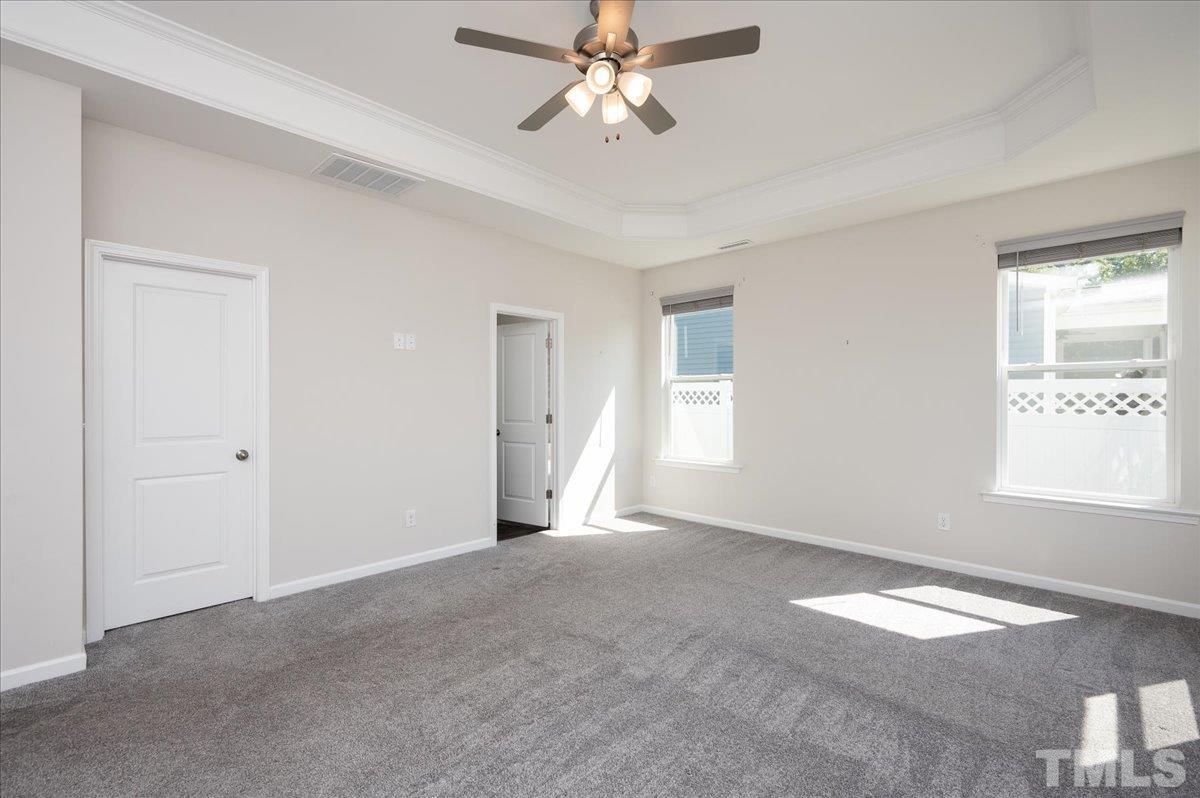 434 Streamliner Boulevard Clayton, NC 27520 - Photo 18 of 27 a view of empty room with window and ceiling fan
