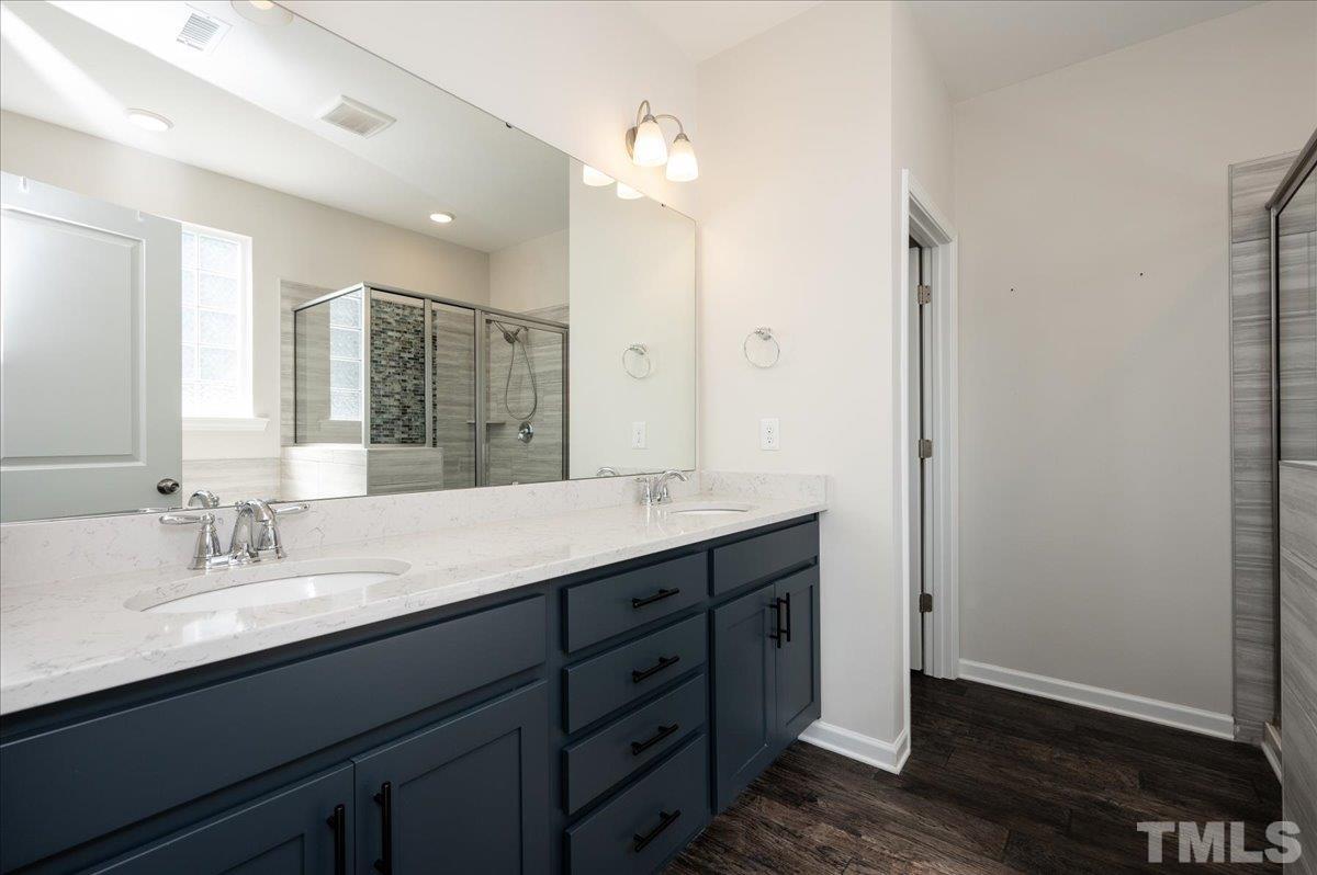 434 Streamliner Boulevard Clayton, NC 27520 - Photo 20 of 27 a bathroom with a double vanity sink and a mirror