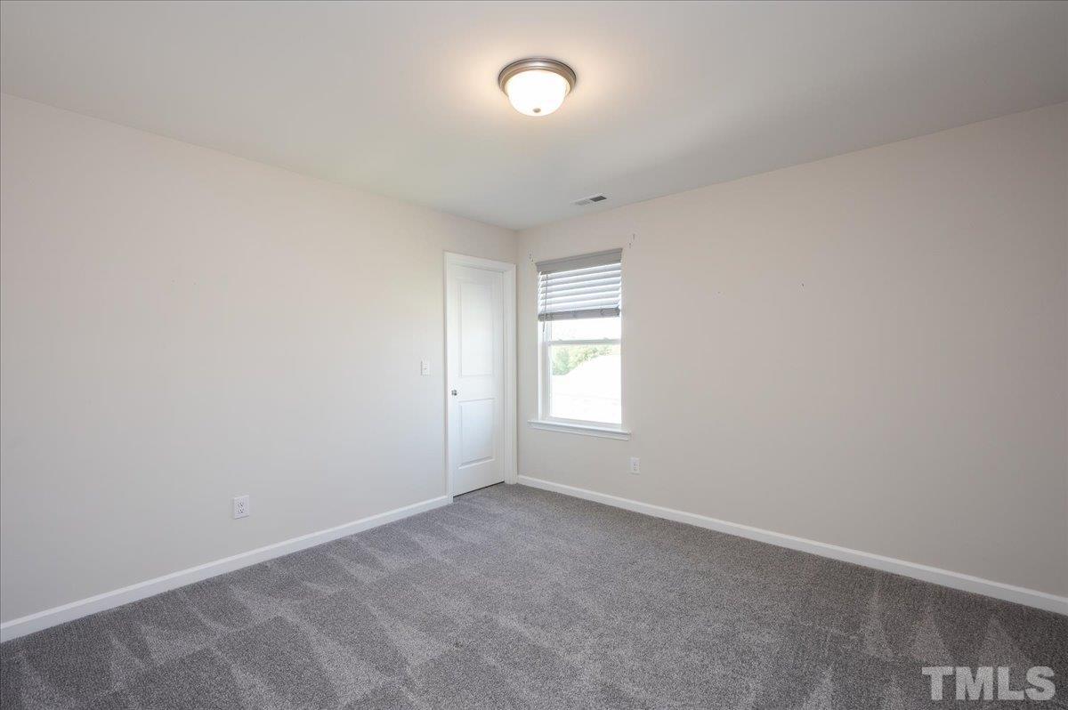 434 Streamliner Boulevard Clayton, NC 27520 - Photo 25 of 27 an empty room with a window