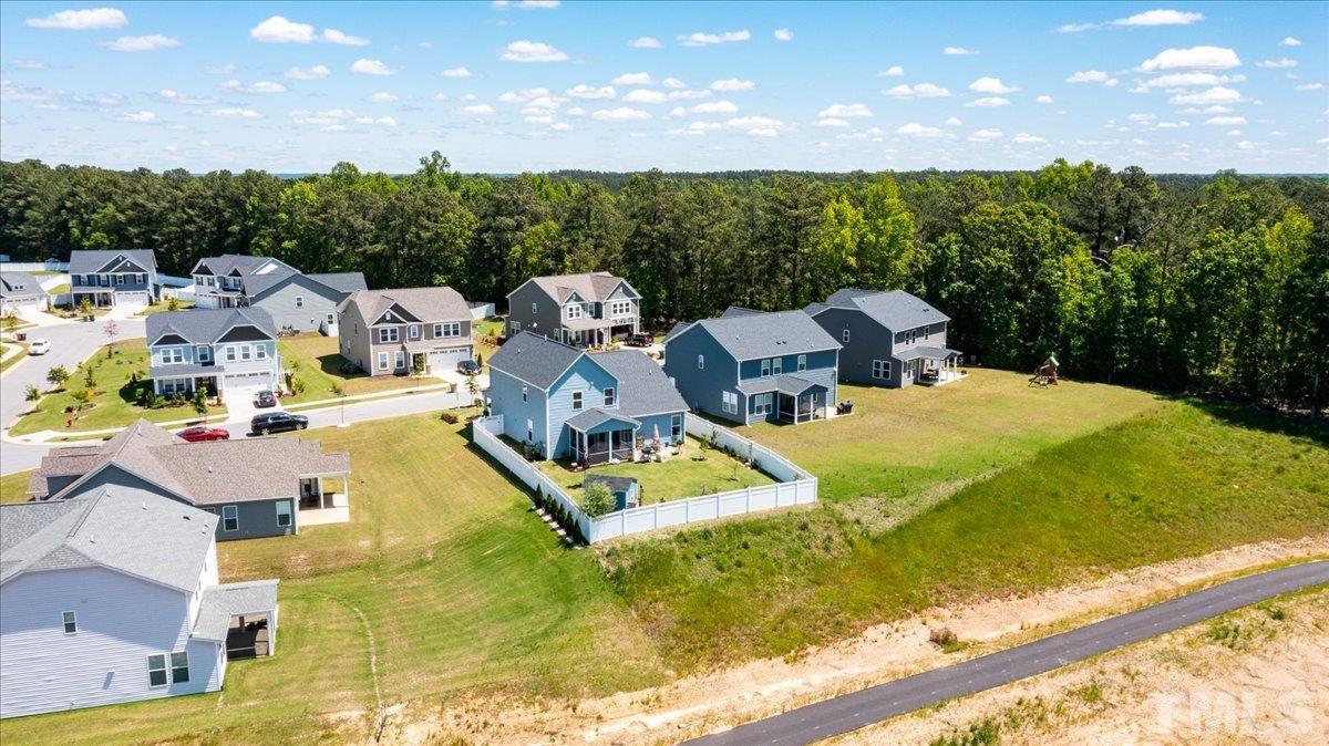 434 Streamliner Boulevard Clayton, NC 27520 - Photo 3 of 27 a view of a swimming pool with seating area and trees in the background
