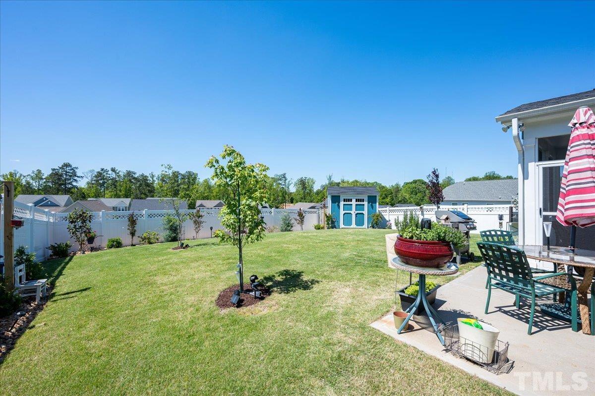 434 Streamliner Boulevard Clayton, NC 27520 - Photo 4 of 27 a view of a backyard with couches under an umbrella