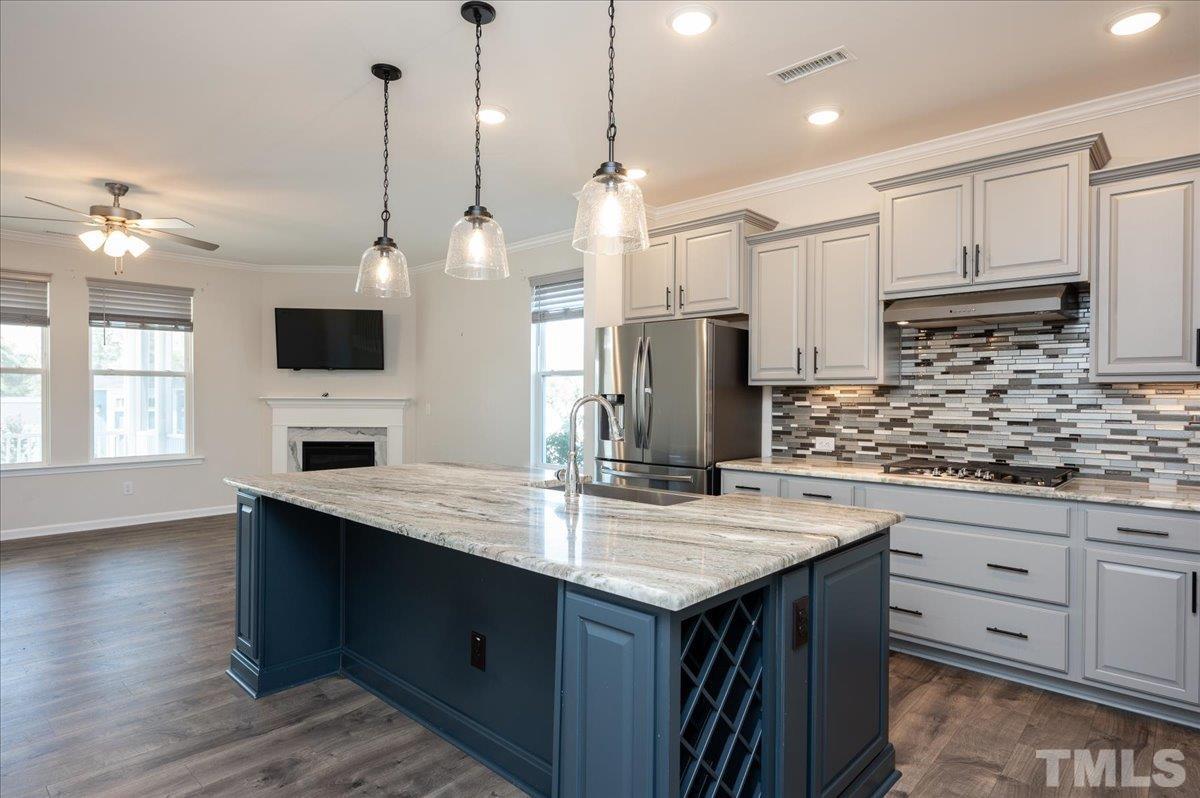 434 Streamliner Boulevard Clayton, NC 27520 - Photo 10 of 27 a kitchen with kitchen island granite countertop a sink appliances and cabinets