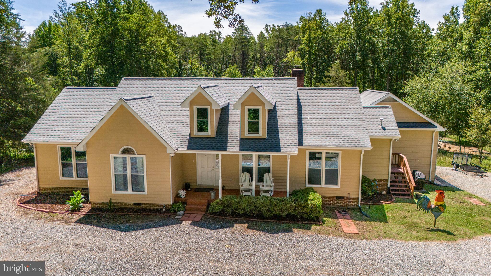 3485 Tabscott Road Columbia, VA 23038 - Photo 39 of 40 a view of a brick house with a yard and large trees