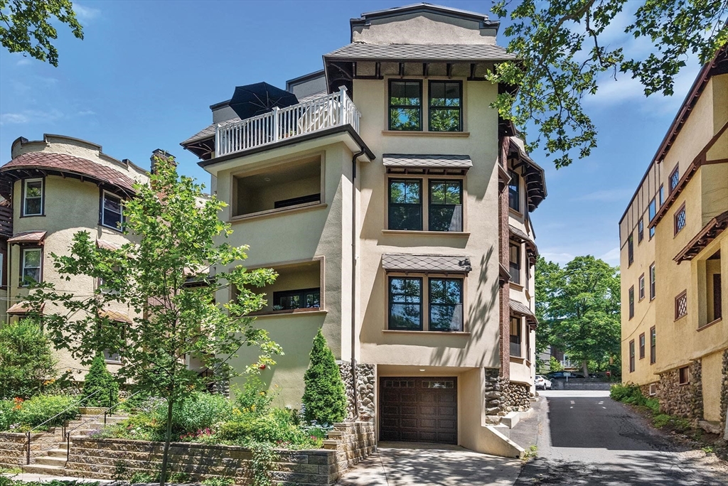 197 Rawson Road, Unit 1 Brookline, MA 02445 - Photo 1 of 27 a front view of a house with a yard