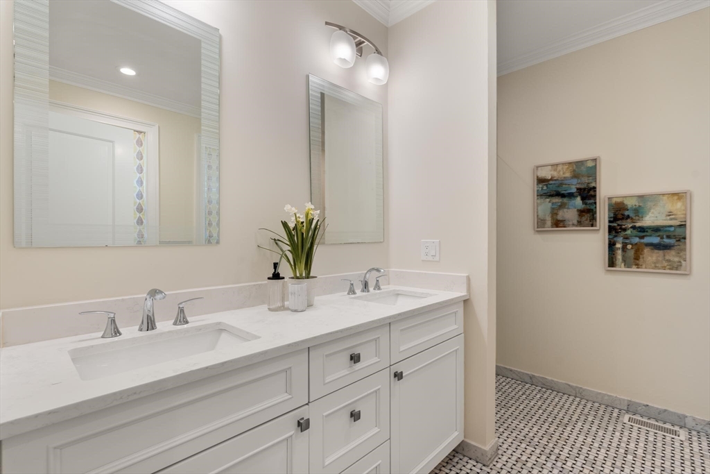 197 Rawson Road, Unit 1 Brookline, MA 02445 - Photo 12 of 27 a bathroom with a sink double vanity and a mirror