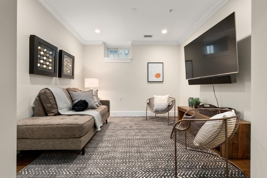 197 Rawson Road, Unit 1 Brookline, MA 02445 - Photo 13 of 27 a living room with furniture and a flat screen tv