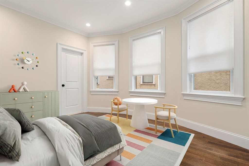 197 Rawson Road, Unit 1 Brookline, MA 02445 - Photo 14 of 27 a bedroom with a bed and wooden floor