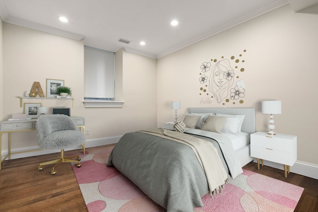 197 Rawson Road, Unit 1 Brookline, MA 02445 - Photo 15 of 27 a bedroom with a bed and painting on the wall