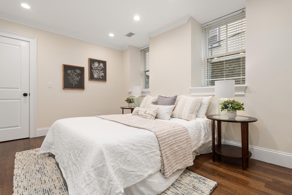 197 Rawson Road, Unit 1 Brookline, MA 02445 - Photo 16 of 27 a bedroom with a bed and wooden floor