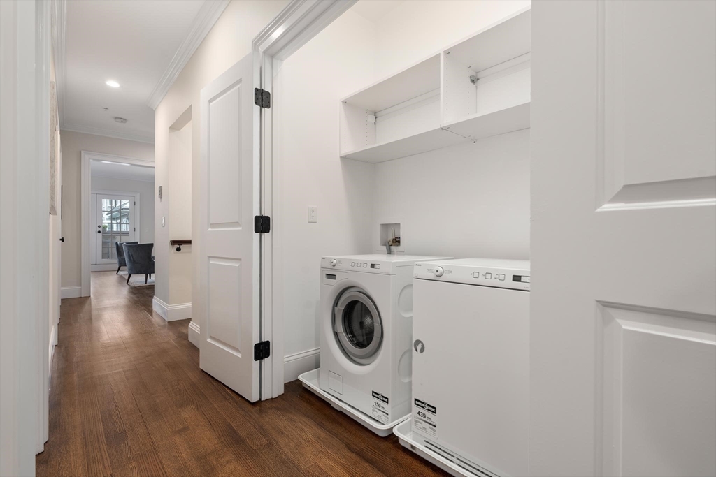 197 Rawson Road, Unit 1 Brookline, MA 02445 - Photo 18 of 27 a view of a hallway with washer and dryer