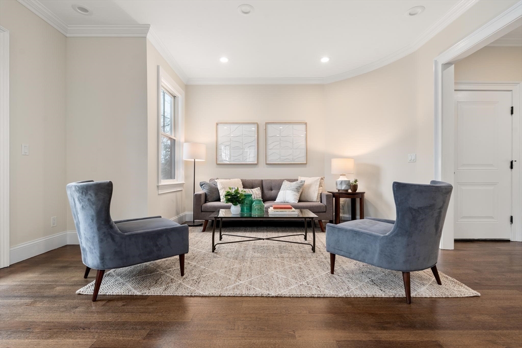 197 Rawson Road, Unit 1 Brookline, MA 02445 - Photo 2 of 27 a living room with furniture and a rug