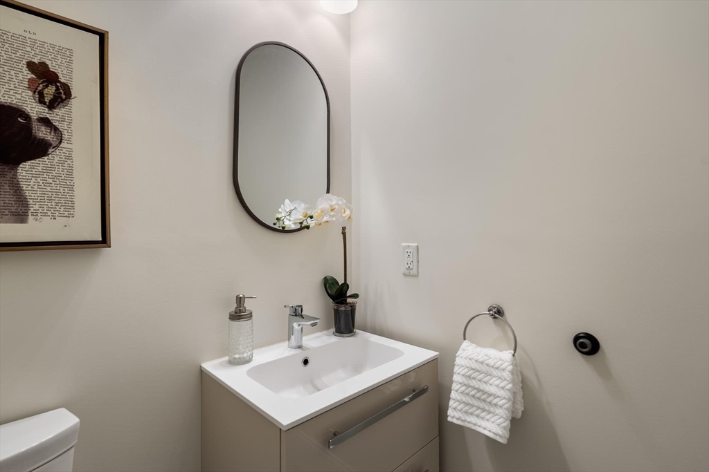 197 Rawson Road, Unit 1 Brookline, MA 02445 - Photo 21 of 27 a bathroom with a sink and a mirror