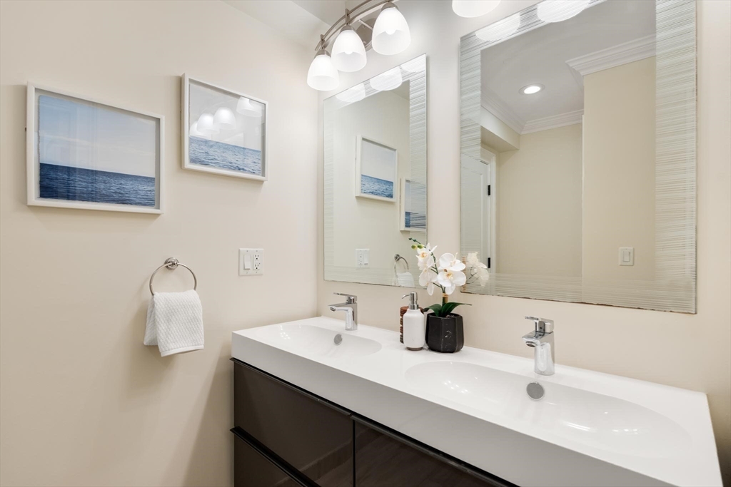 197 Rawson Road, Unit 1 Brookline, MA 02445 - Photo 22 of 27 a bathroom with a sink vanity and mirror