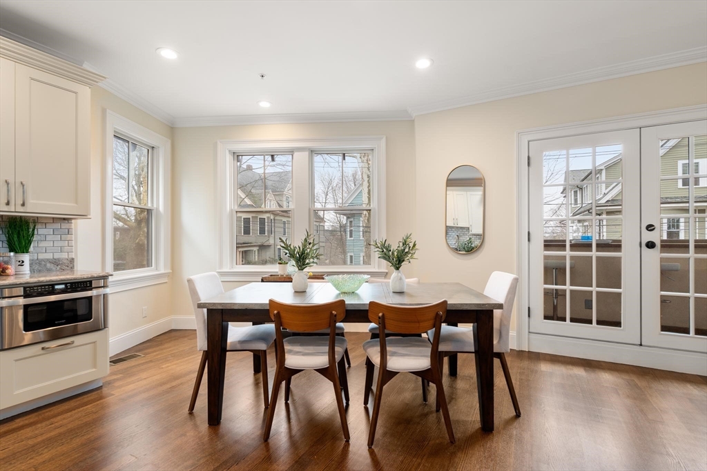 197 Rawson Road, Unit 1 Brookline, MA 02445 - Photo 7 of 27 a view of a dining room with furniture window and wooden floor