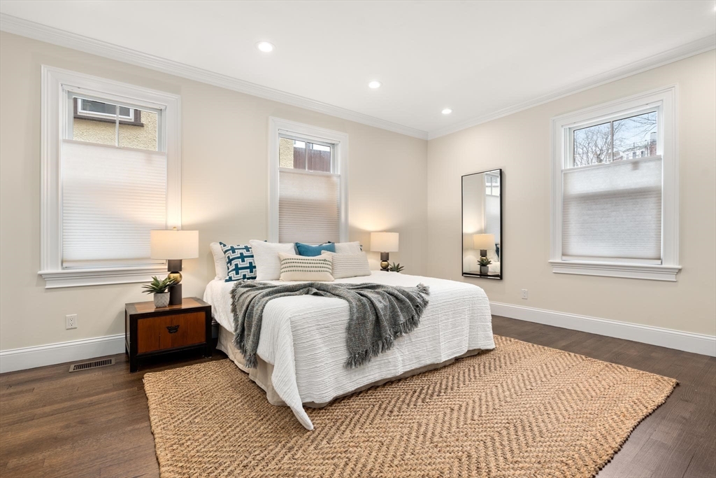 197 Rawson Road, Unit 1 Brookline, MA 02445 - Photo 8 of 27 a bedroom with a large bed and a window