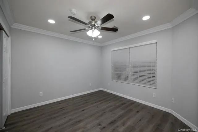a view of wooden floor and a chandelier fan in a room
