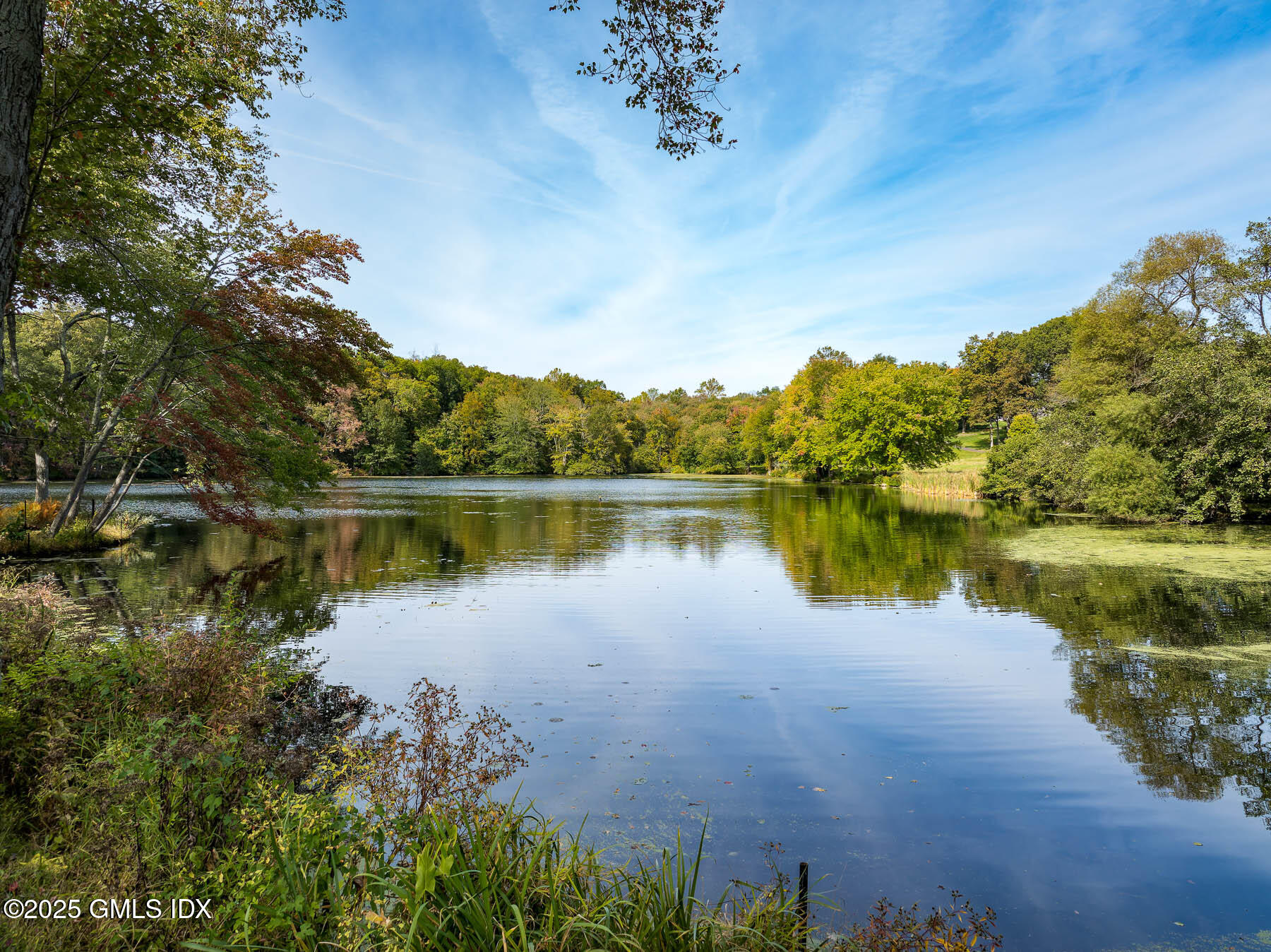 65 John Street Greenwich, CT 06831 - Photo 3 of 12 a view of a lake with a house in the background