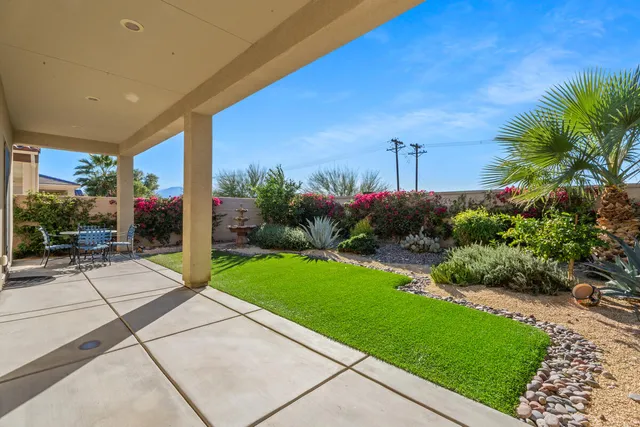 a kitchen with granite countertop a sink and a refrigerator