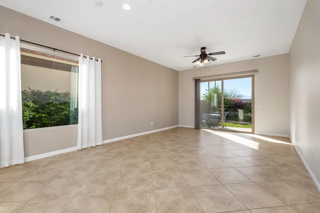 a row of palm trees in front of a building