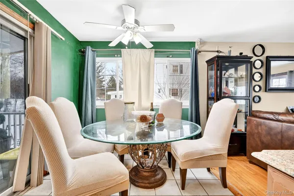 a dining room with furniture a livingroom view and wooden floor