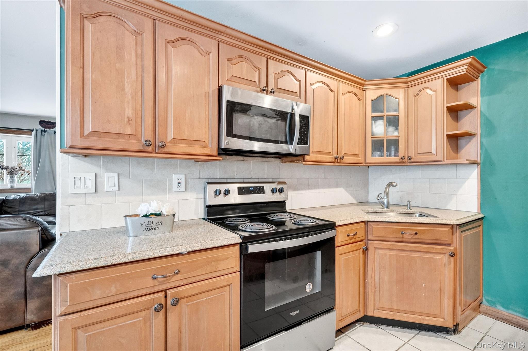 35 Maple Lane Monroe, NY 10950 - Photo 14 of 48 a kitchen with stainless steel appliances granite countertop a sink a stove and a microwave