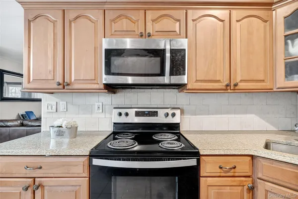 a kitchen with granite countertop a stove sink and cabinets