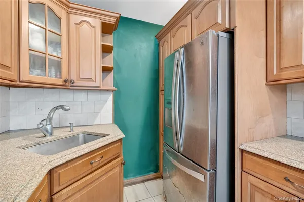 a kitchen with stainless steel appliances granite countertop a refrigerator and a sink
