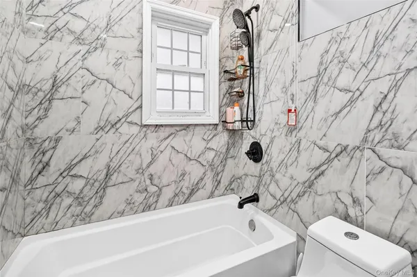 a bathroom with a bathtub and shower