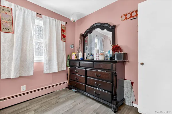 a room with a dresser and a window