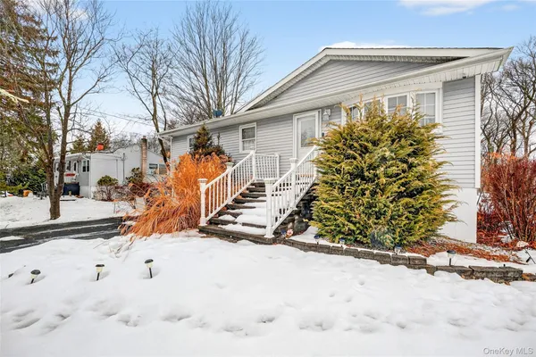 a view of a house with snow on the road