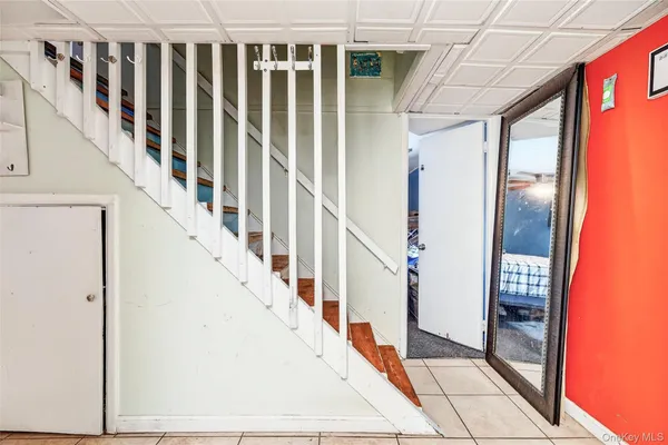 a view of staircase with railing and white walls