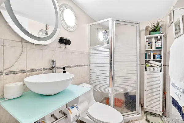 a bathroom with a toilet a sink and a mirror