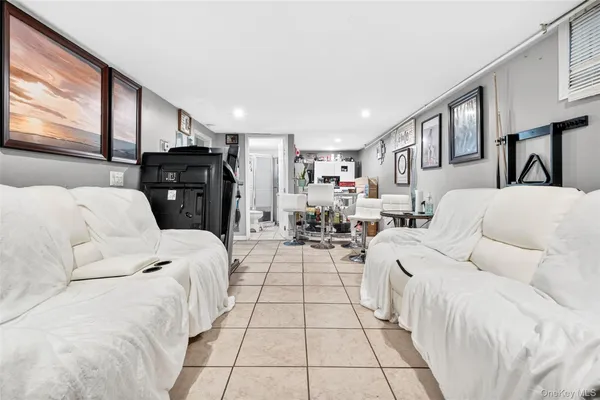 a living room with furniture fireplace and a large window